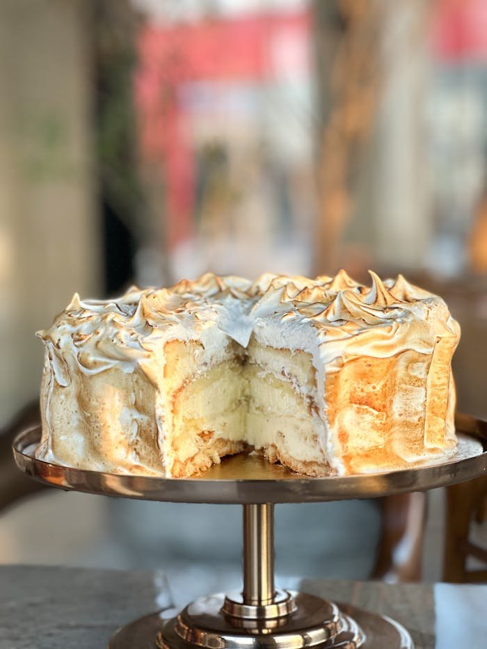 Elegant meringue-topped layer cake slice, perfect for celebrations.